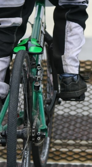 person riding green hardtail bike of concrete surface thumbnail