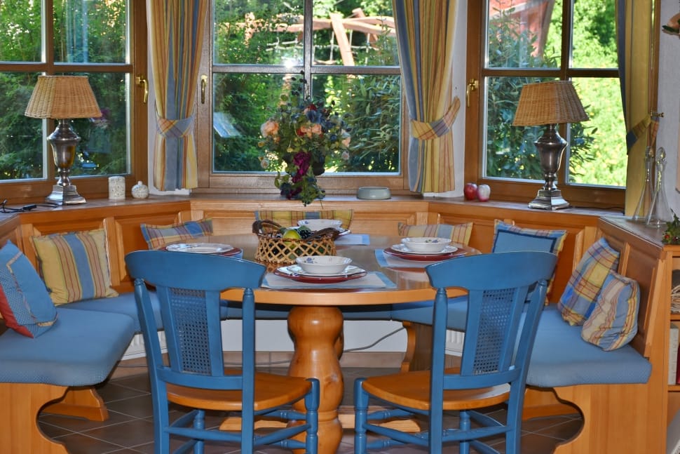 brown wooden table and brown and blue wooden chairs preview