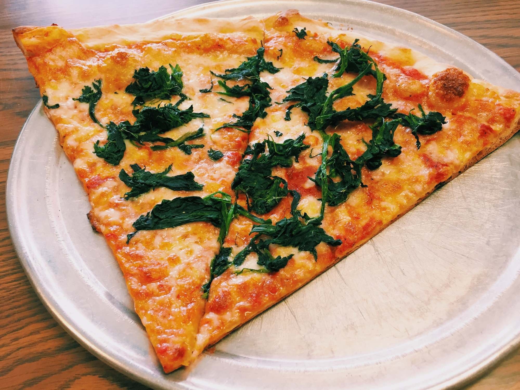 cheese thin crust pizza with green herbs
