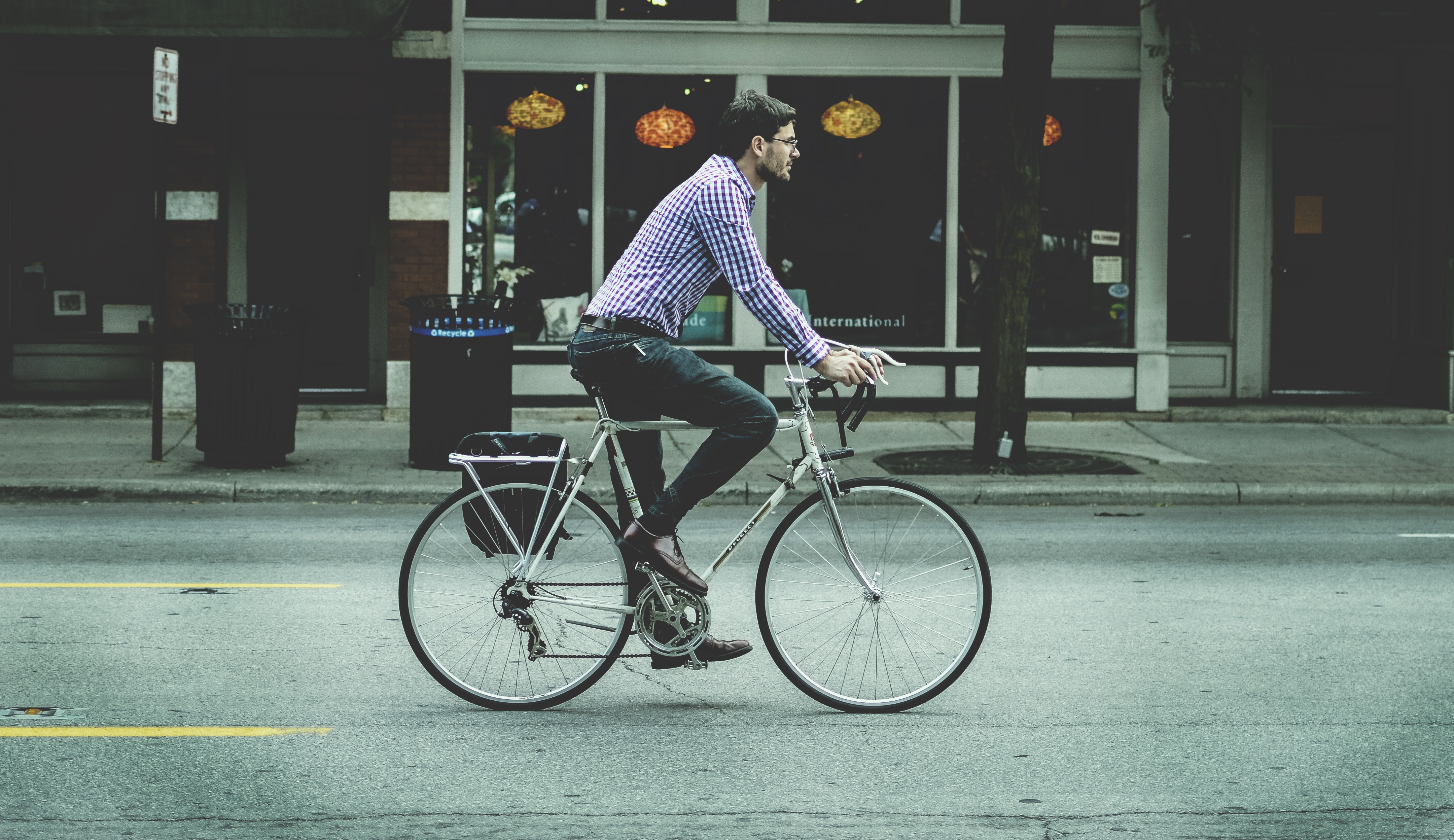 man riding on silver commuter bike