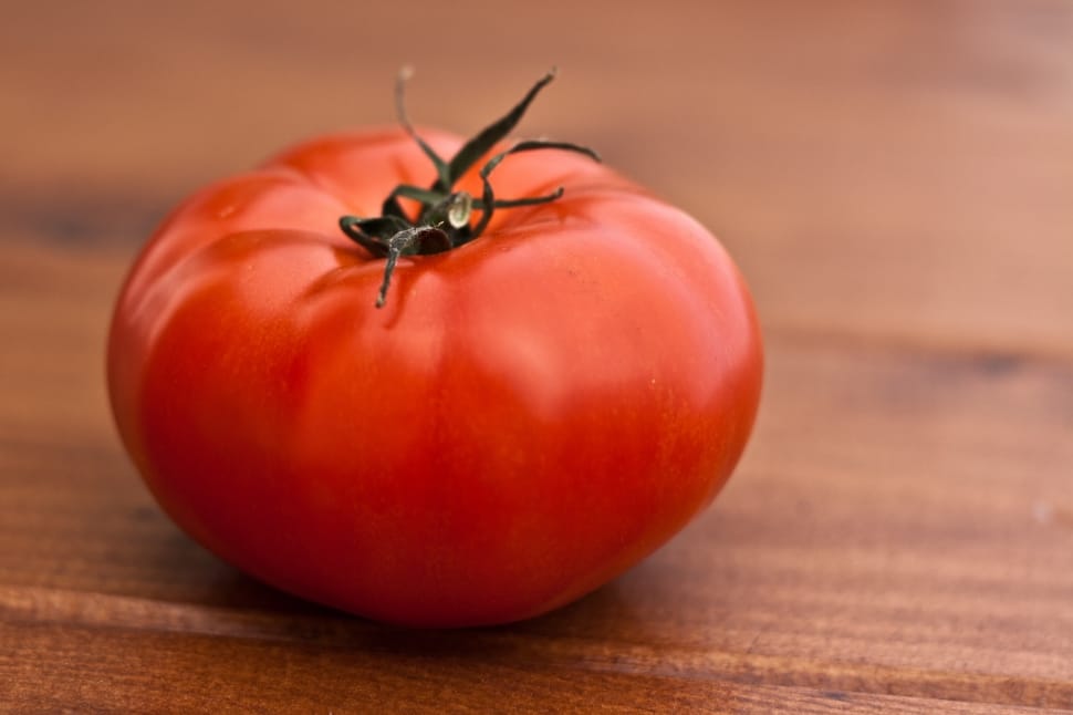 selective focus photography of red tomato on top of brown surface preview