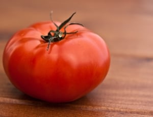 selective focus photography of red tomato on top of brown surface thumbnail