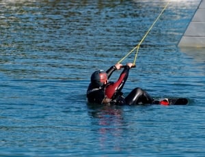 person's black and red wetsuit thumbnail