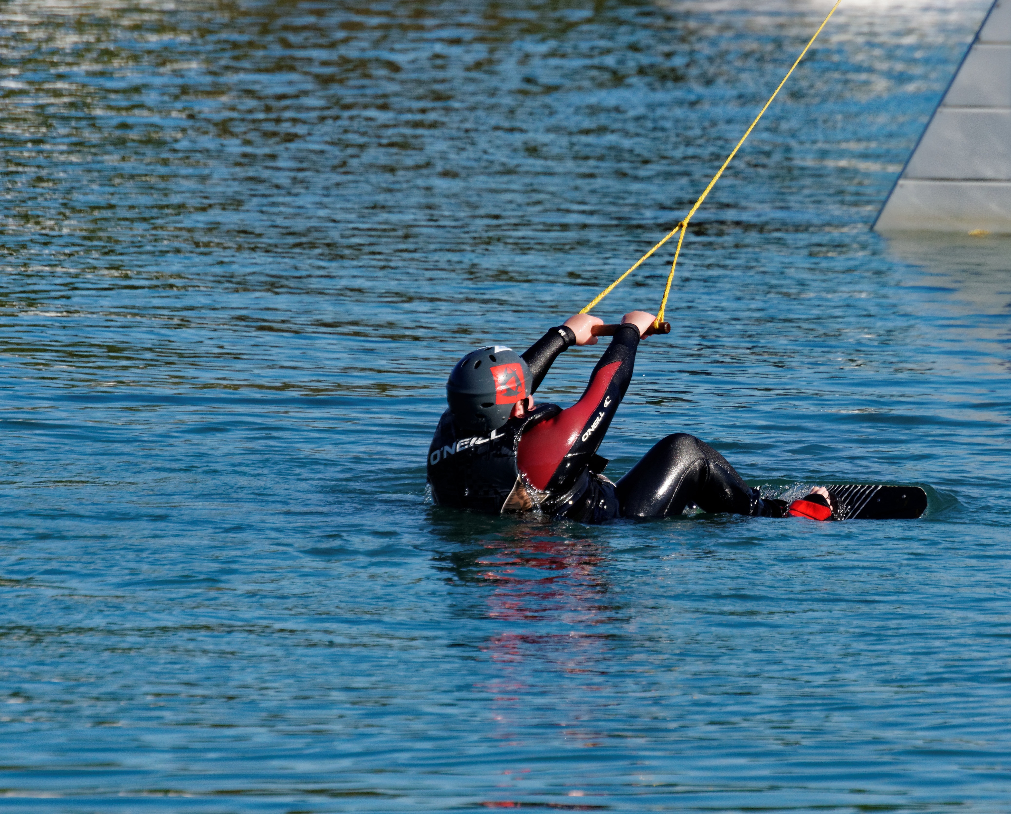 person's black and red wetsuit