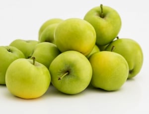 bunch of green apple on white surface thumbnail