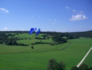 man in white and blue parachute thumbnail