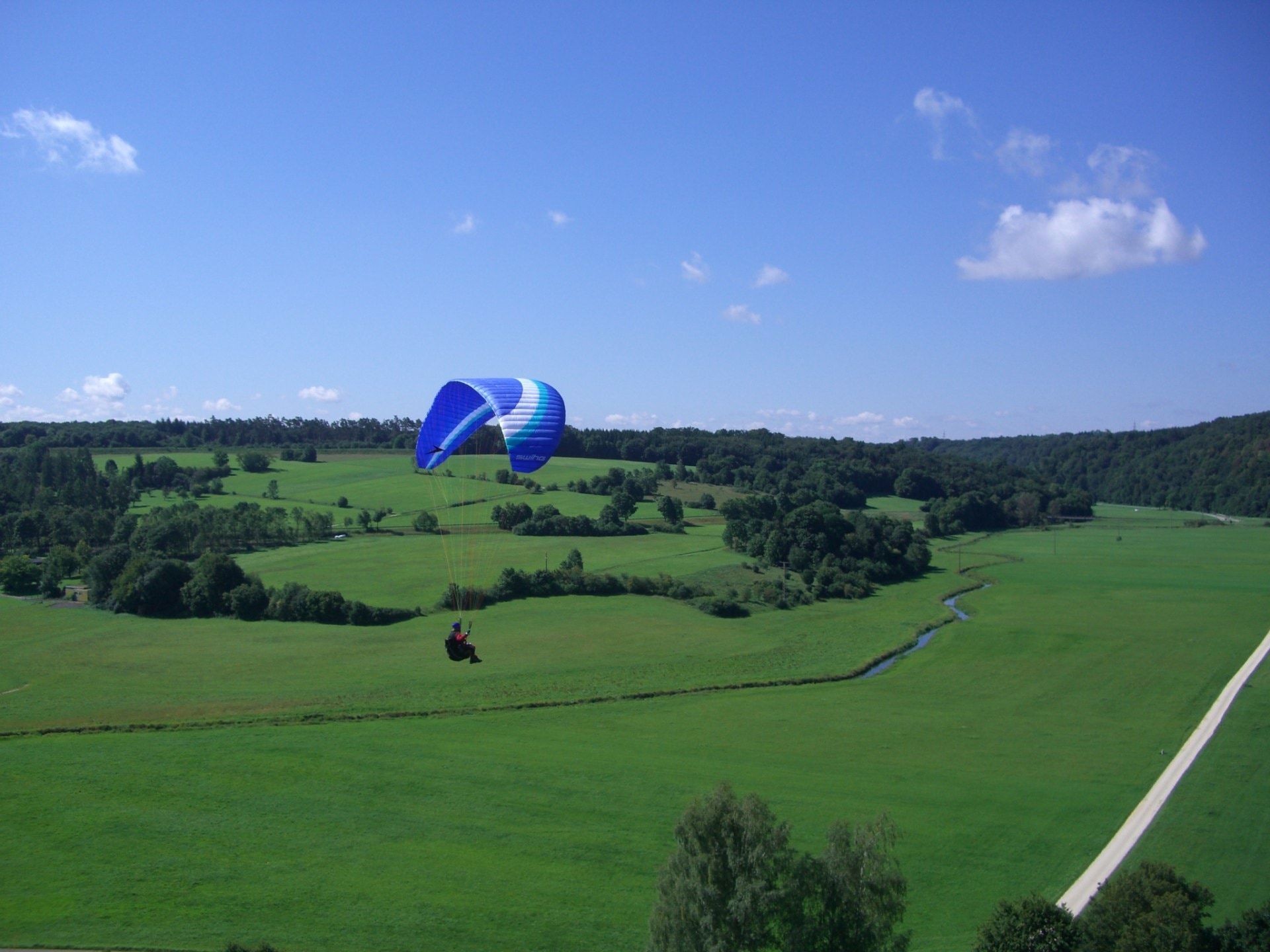 man in white and blue parachute