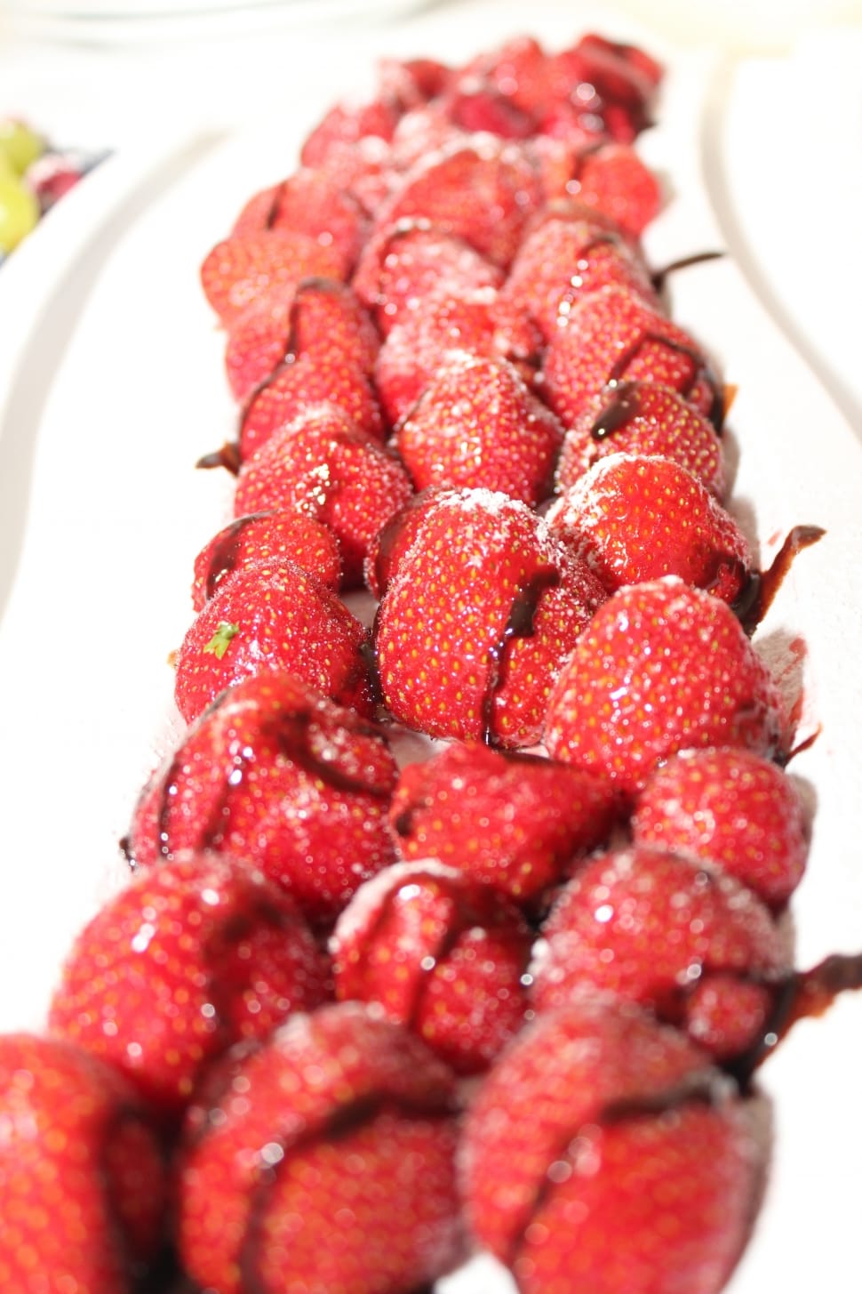 red strawberries drizzled with chocolate on plate preview