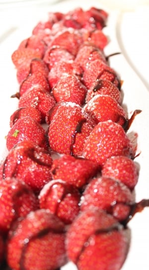 red strawberries drizzled with chocolate on plate thumbnail