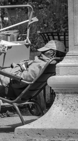 man sleeping on armchair grayscale photo thumbnail