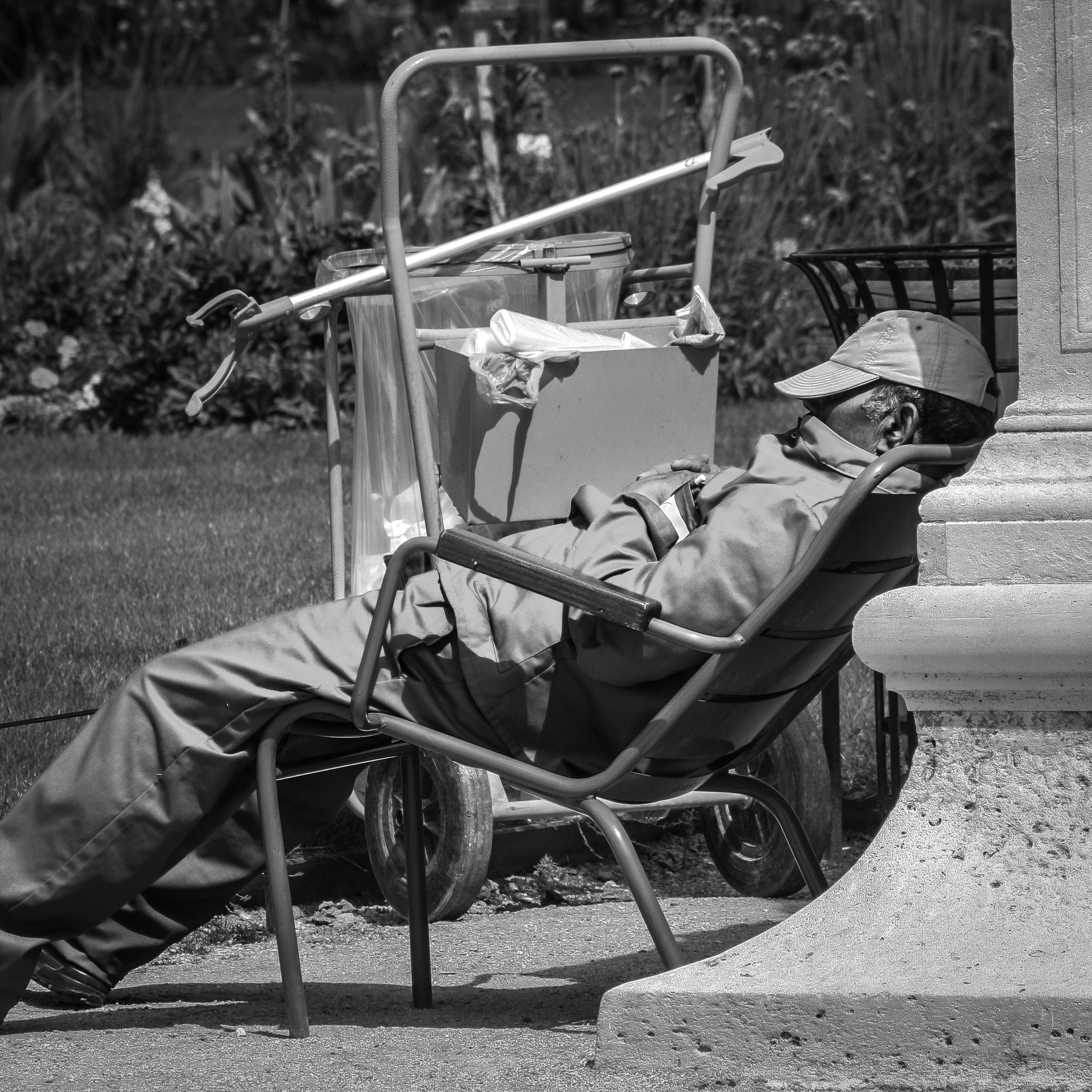 man sleeping on armchair grayscale photo