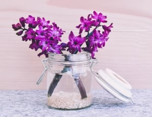 purple hyacinths in clear slom jar centerpiece thumbnail