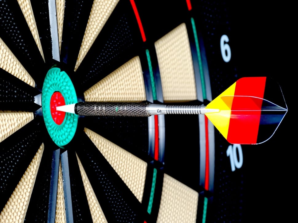 yellow, red and black dart marked on the bull's eye target of dart board preview