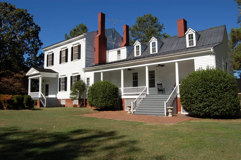 white and gray 2 storey house with lawn and bushes preview