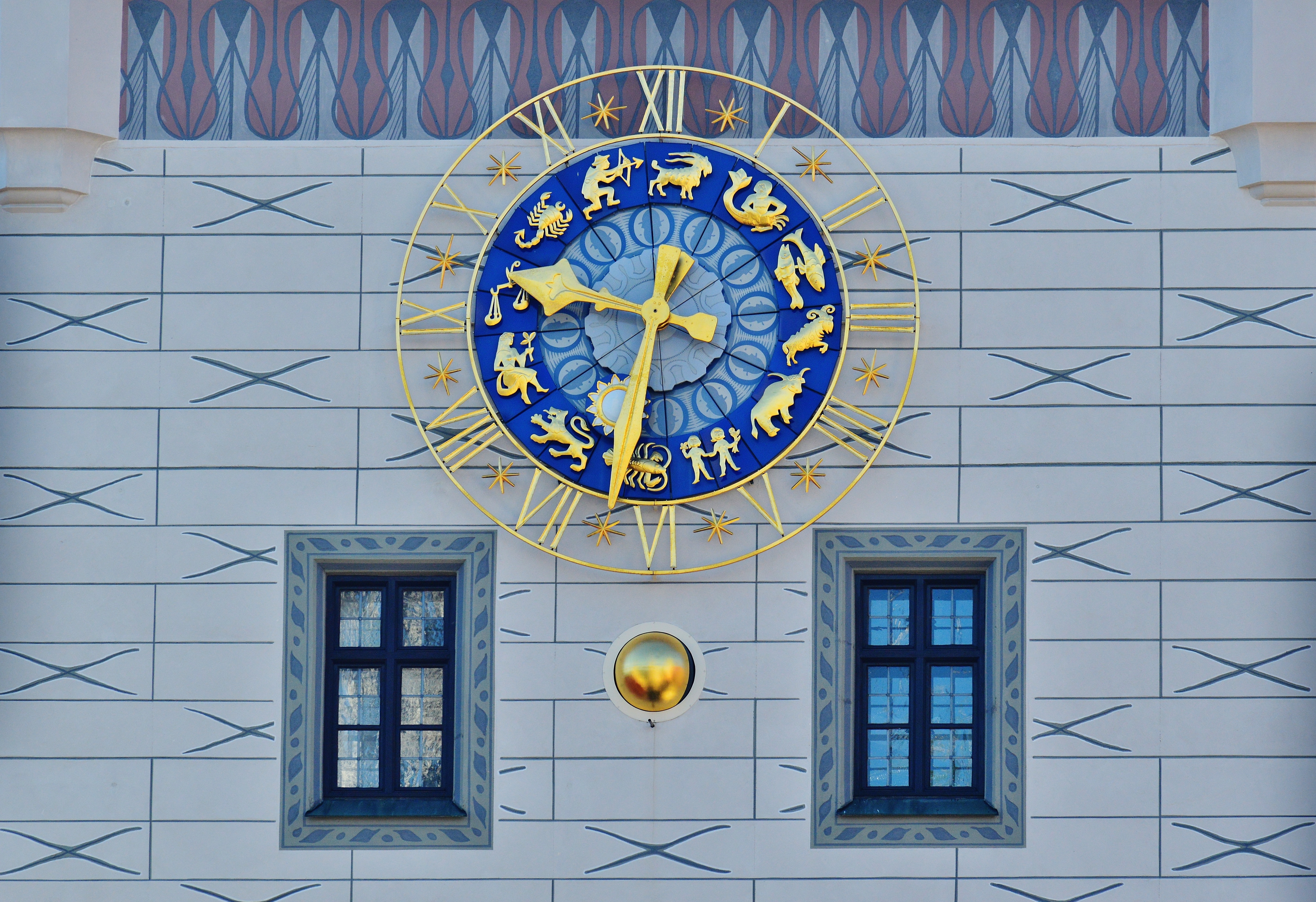 brass and blue round horoscole analog clock