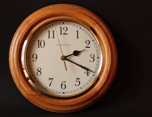brown and white wooden round wall clock at 2:19 thumbnail