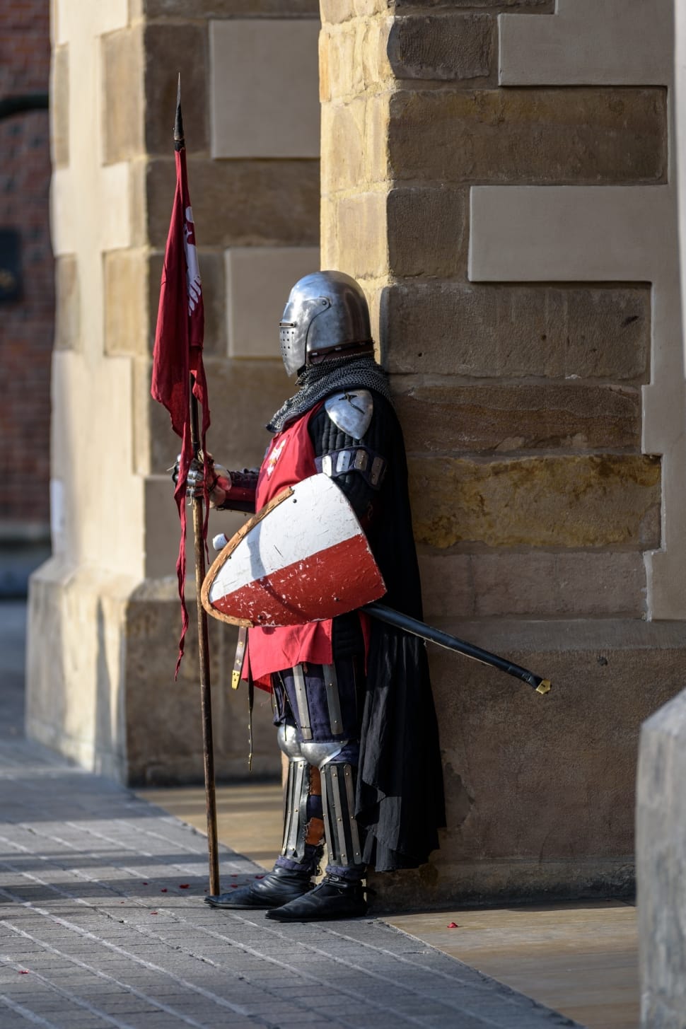 knight holding white and red knight shield during daytime preview