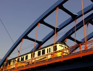 train crossing on gray metal bridge rail thumbnail