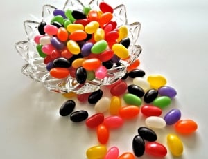assorted color jelly beans on clear cut crystal glass bowl thumbnail