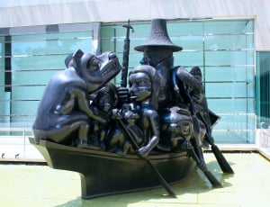 people and person riding boat statue thumbnail