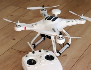 white and black quadcopter drone thumbnail