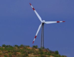 white and red windmill on top of mountain thumbnail