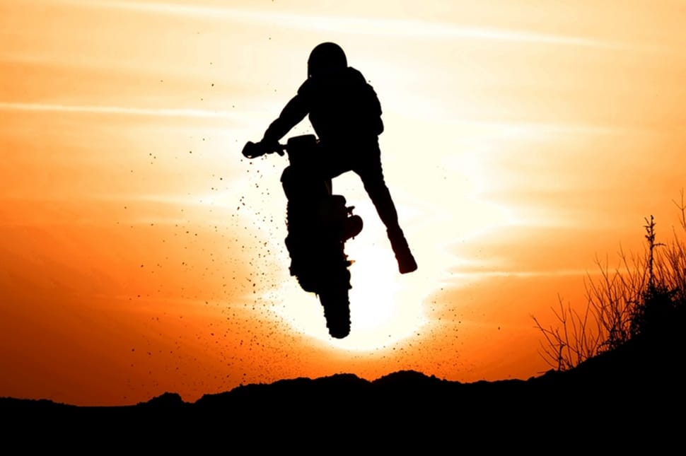 silhouette photo of man riding motorcycle preview
