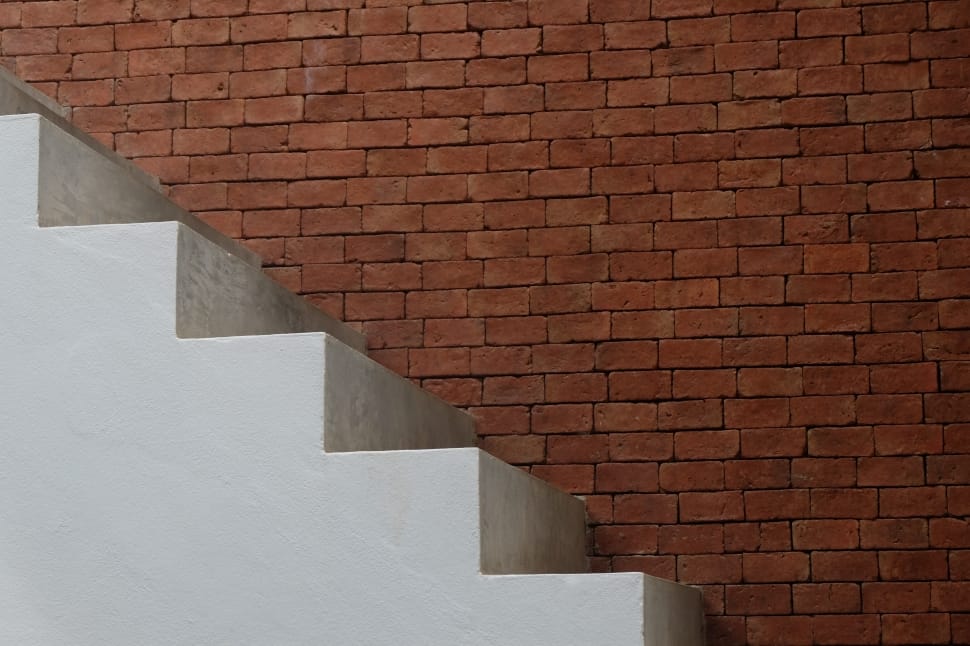 white concrete stairs and brown bricked wall preview