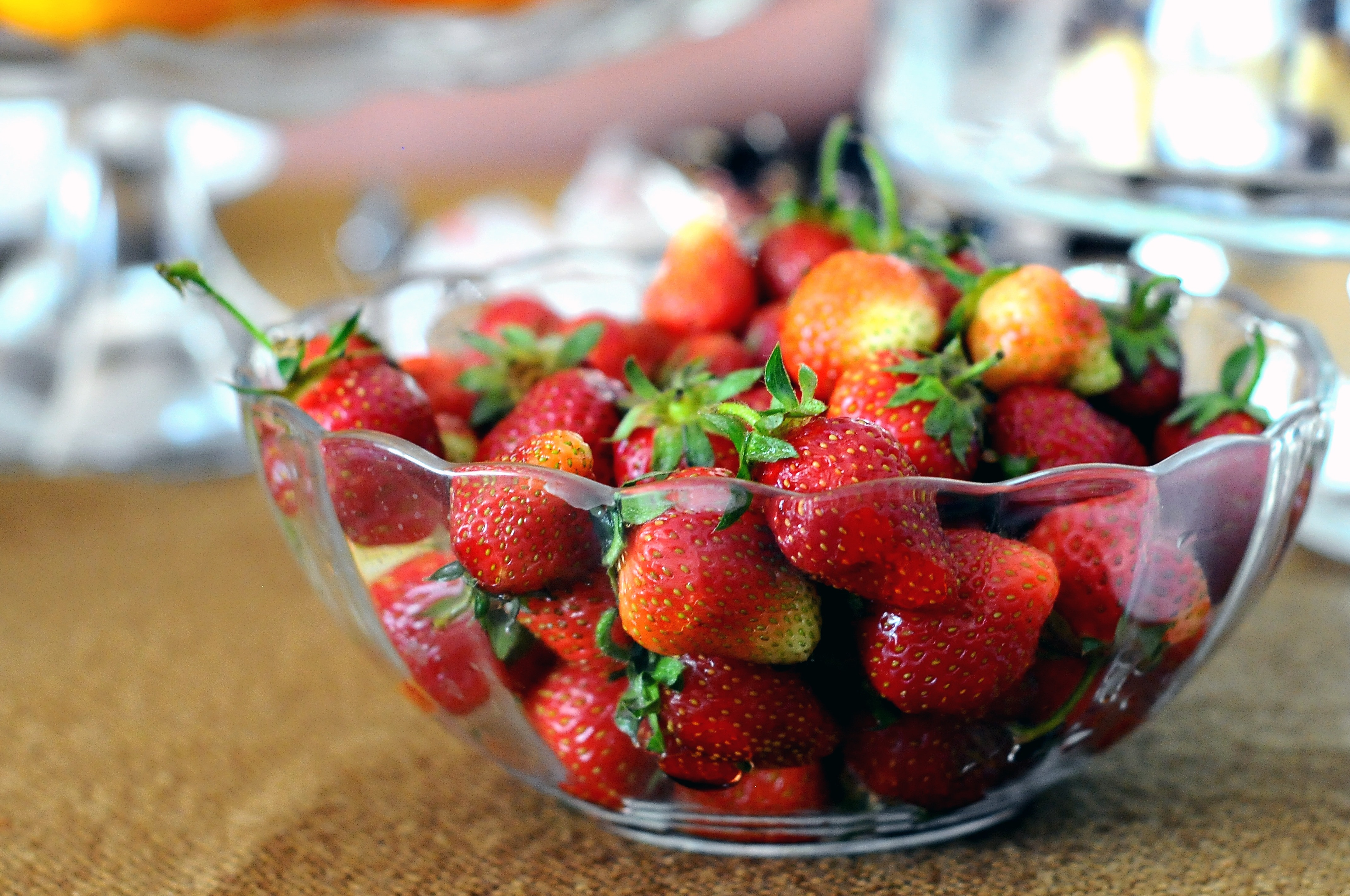 strawberries in clear glass bowl