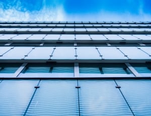 worm's eyeview of white concrete building during daytime thumbnail