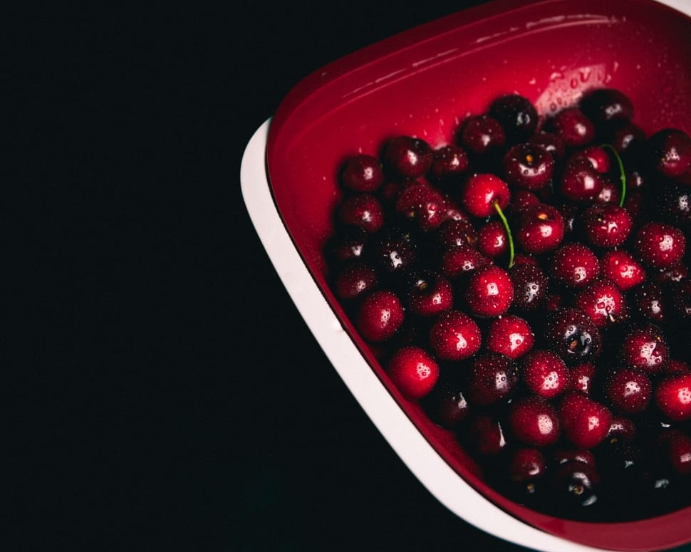 cherries  on red plastic bowl preview