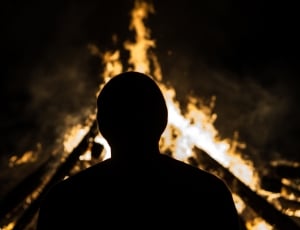 man took a photo in front of fire thumbnail