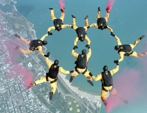 group of people doing sky diving wearing yellow uniform thumbnail