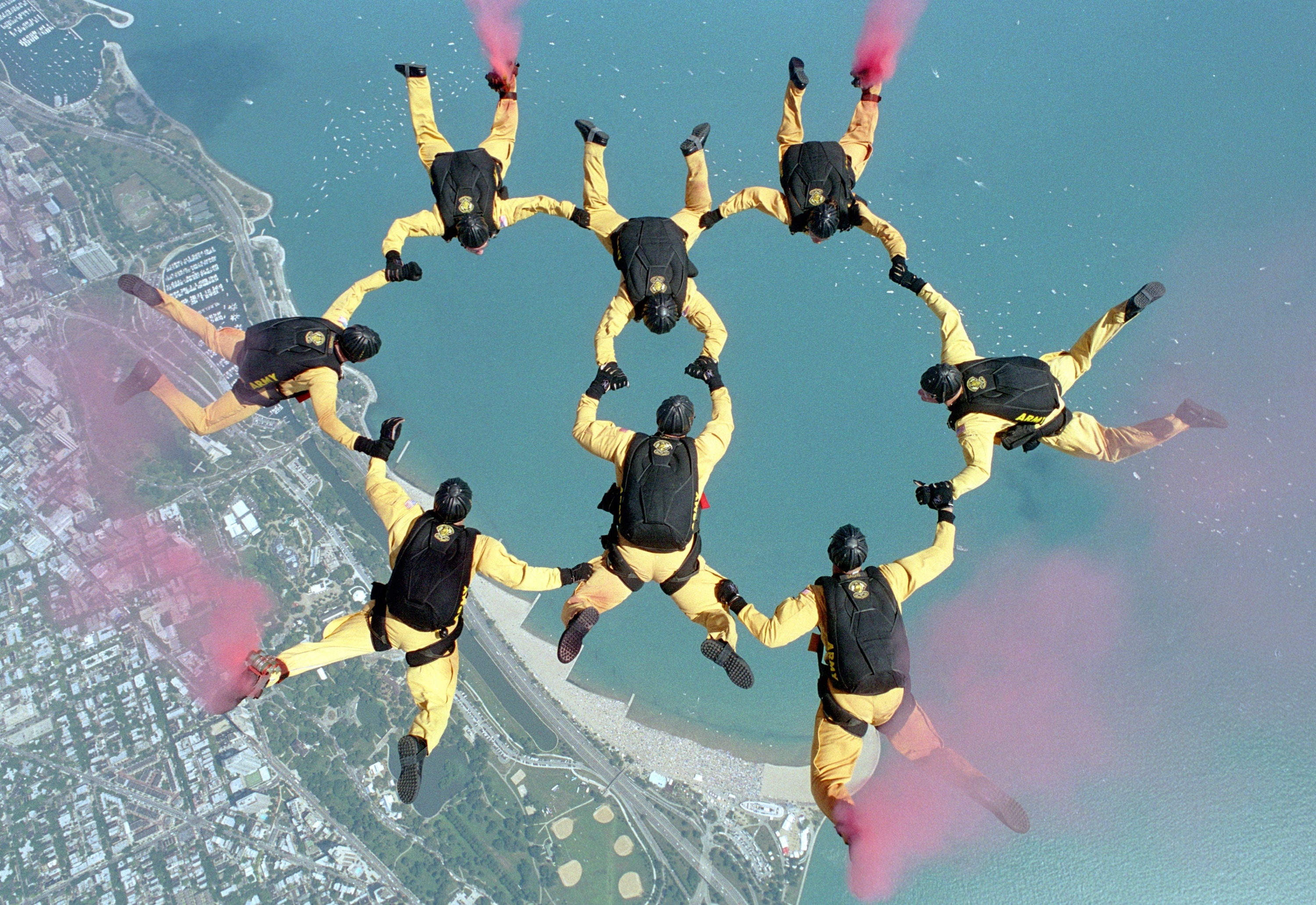 group of people doing sky diving wearing yellow uniform