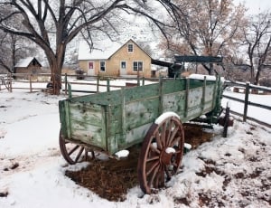 green wagon on snow during daytime thumbnail