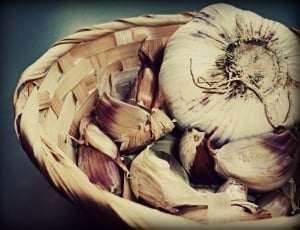 garlic and onions in brown woven basket thumbnail