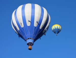 2 white blue and yellow hot air balloons thumbnail