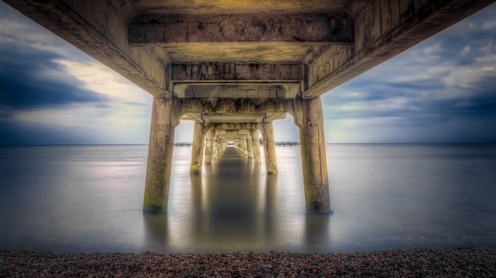 architectural photography of brown concrete bridge near body of water preview