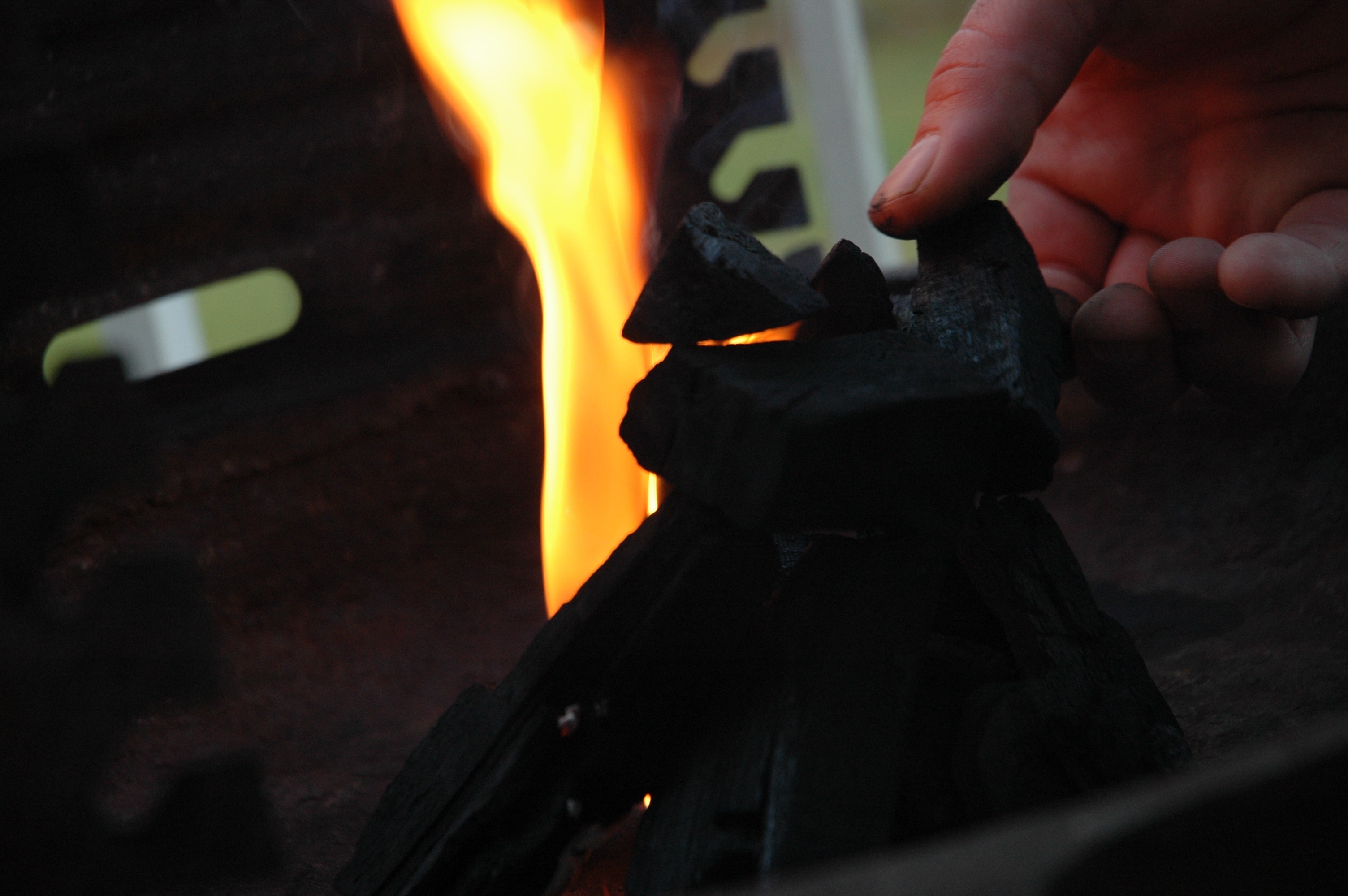 person holding charcoal near flame