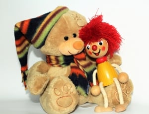 teddy bear and red haired wooden doll thumbnail