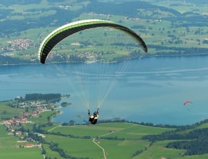 green white and black paragliding thumbnail