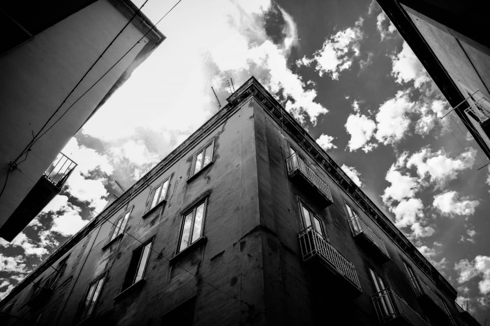 grayscale photo of building and clouds preview