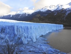glacier near body of water thumbnail