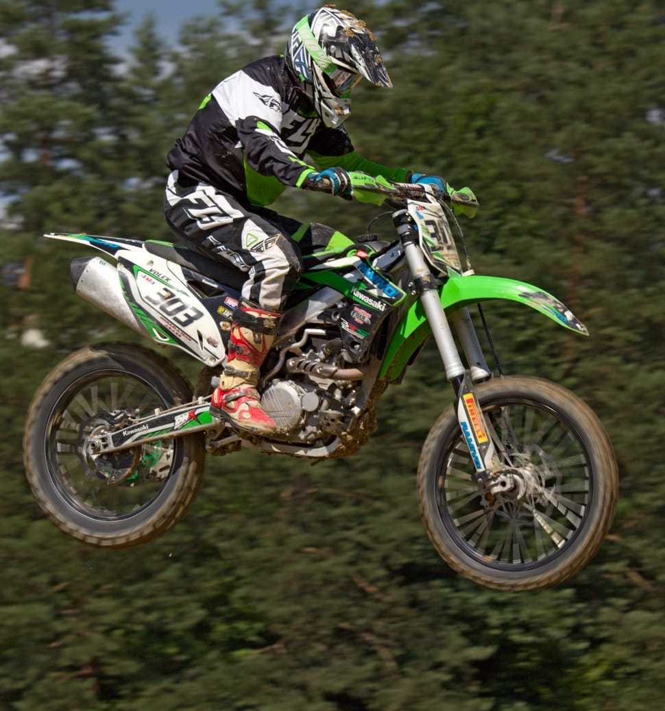 person riding on green motocross dirt bike preview