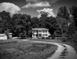 grayscale photograph of house and trail thumbnail