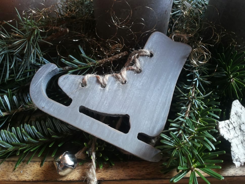 wooden ice skate on fir tree leaves preview