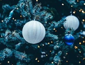 silver baubles near and blue baubles in christmas tree decor thumbnail