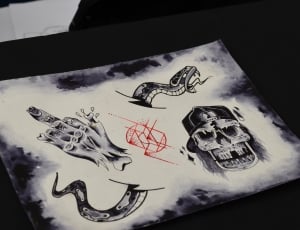 black and white skull print on black surface thumbnail
