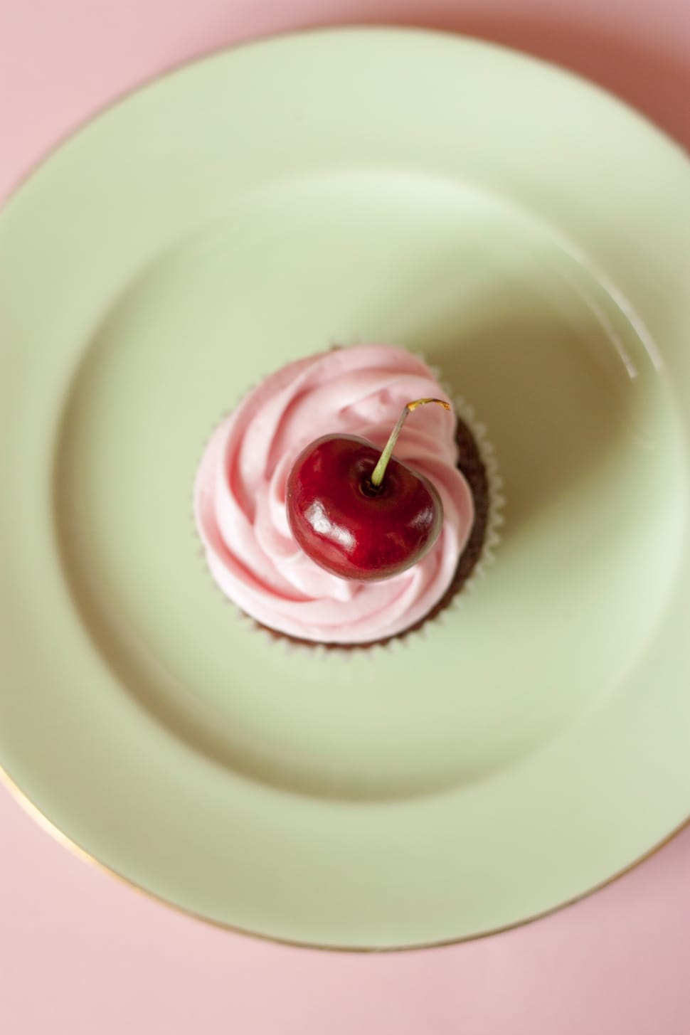 cherry cupcake on green ceramic plate preview