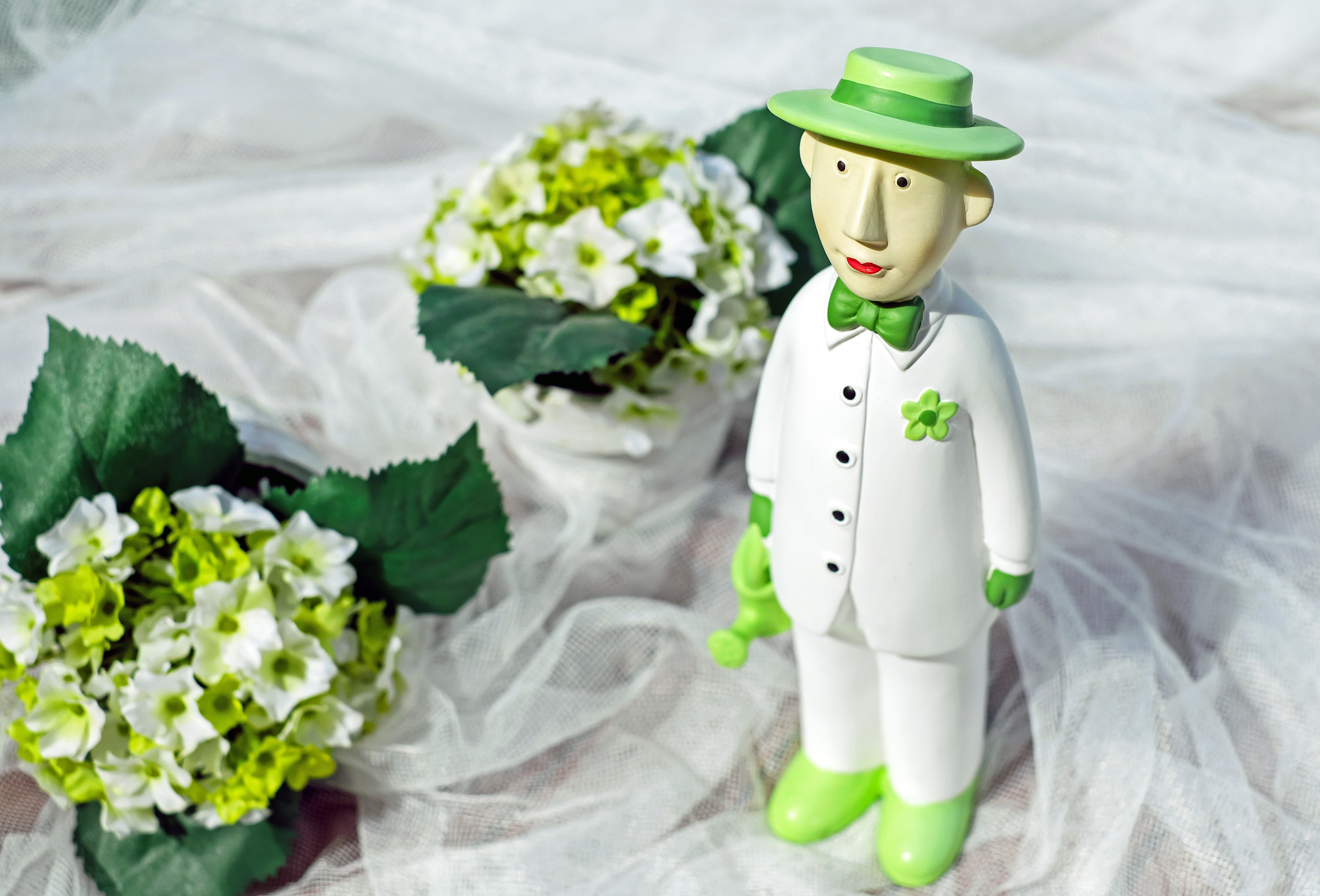 man in green hat and white dress shirt and pants ceramic figurine